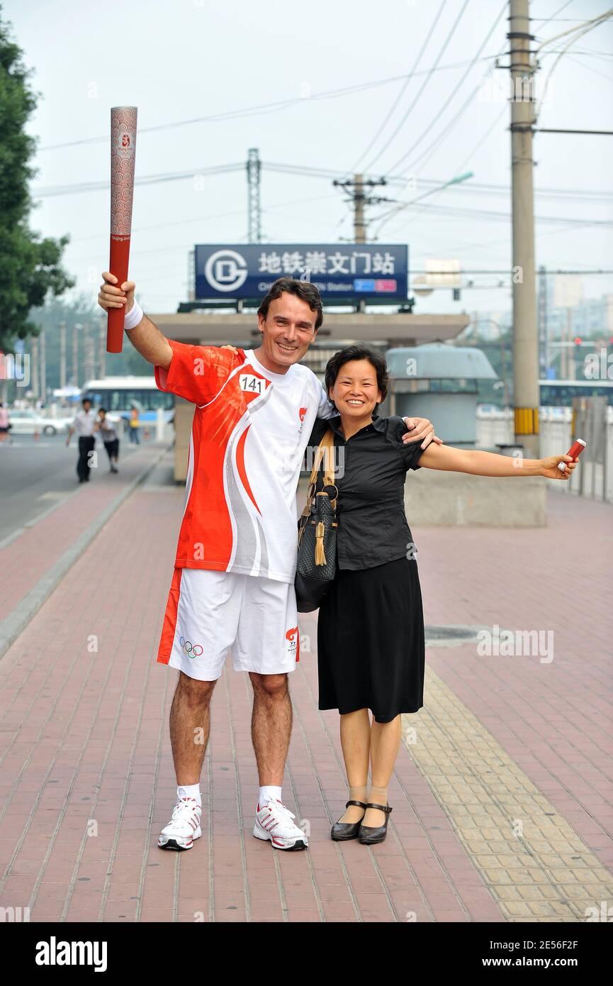 CEO of Carrefour China Eric Legros poses with the olympic flame