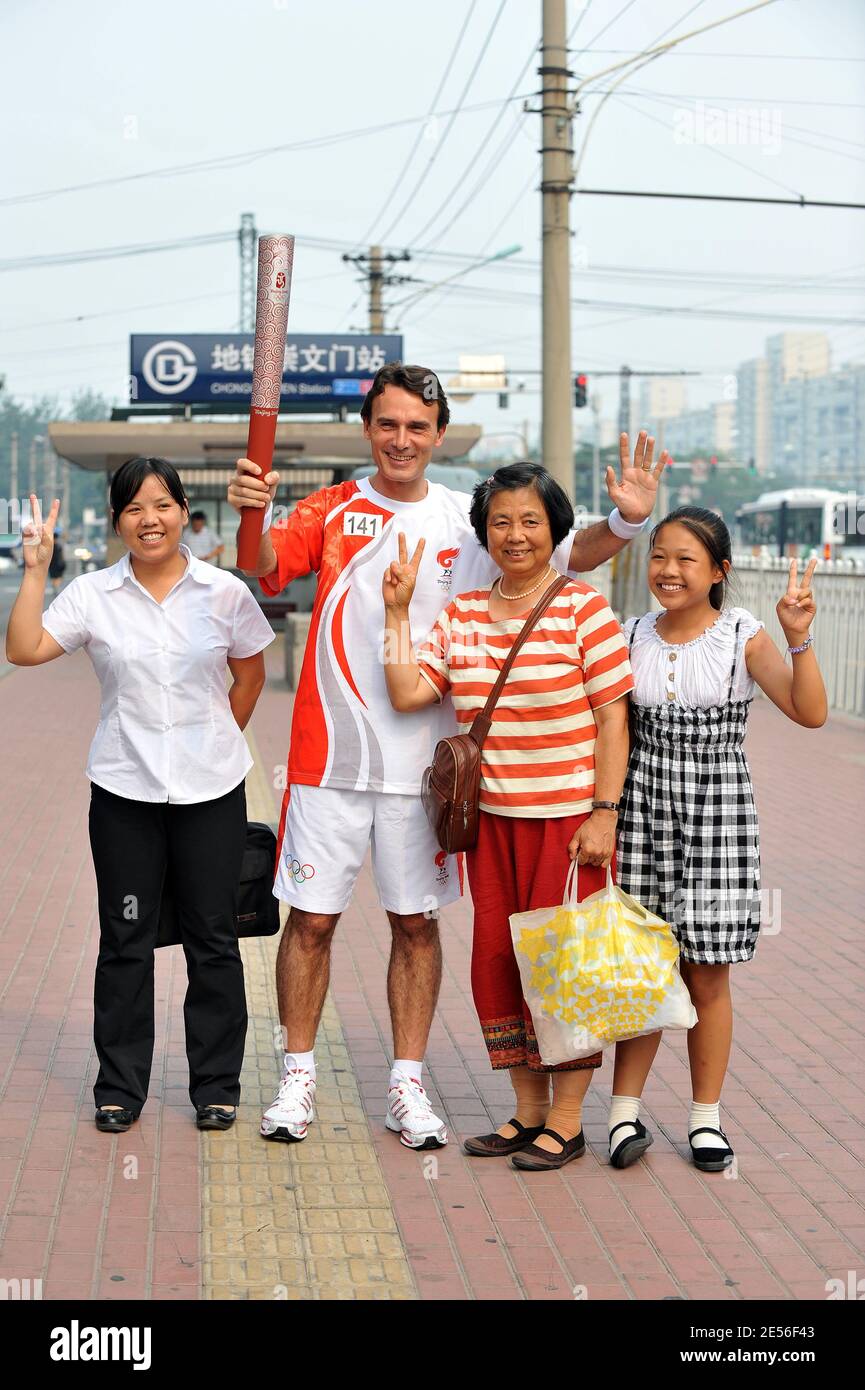 CEO of Carrefour China Eric Legros poses with the olympic flame