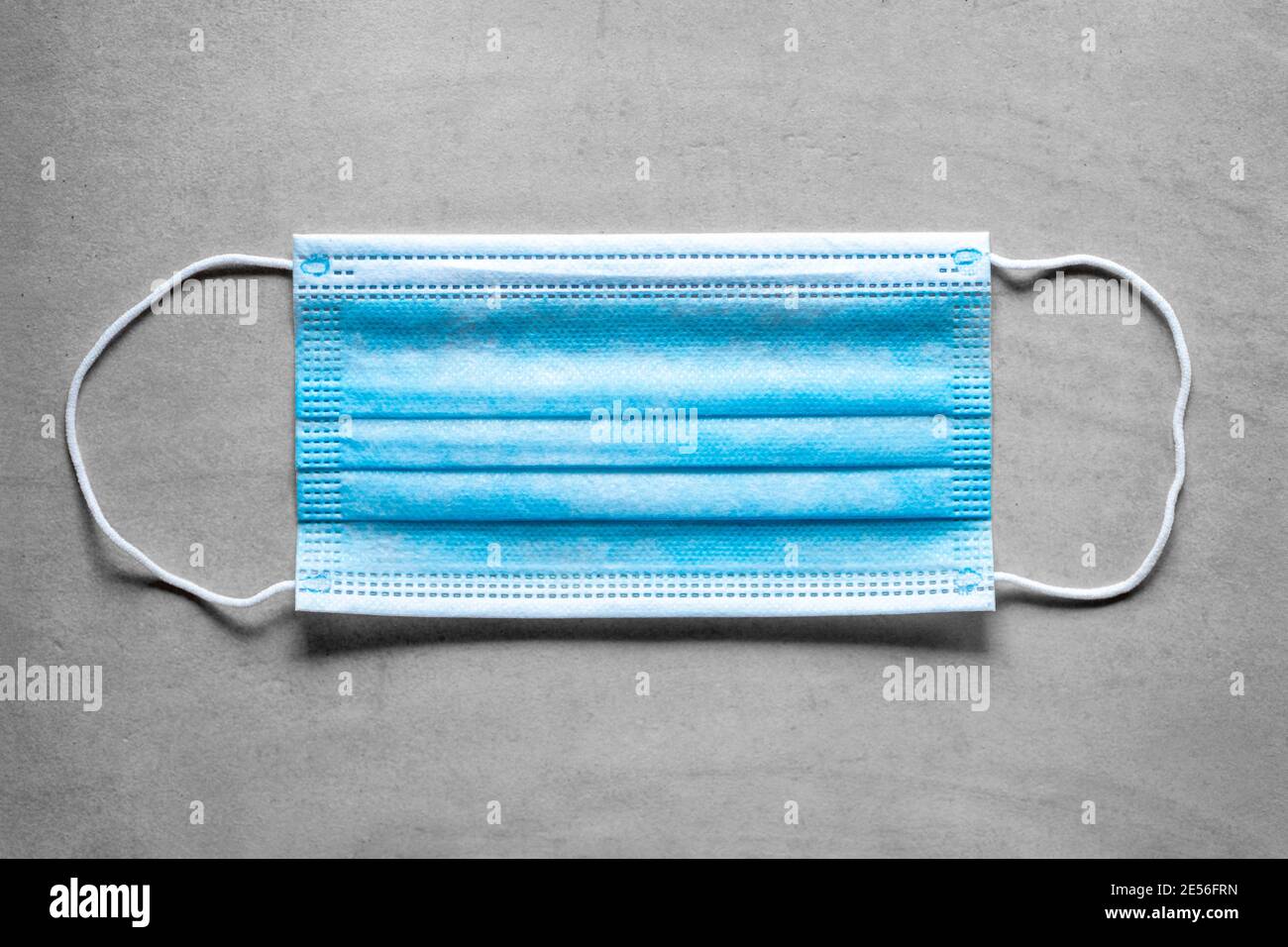 Covid-19 medical surgical face mask. Coronavirus mouth protection on gray background Stock Photo