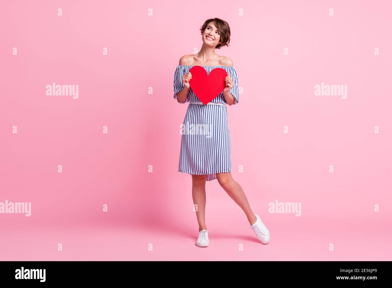 Photo portrait of dreamy girl holding big red heart card isolated on ...