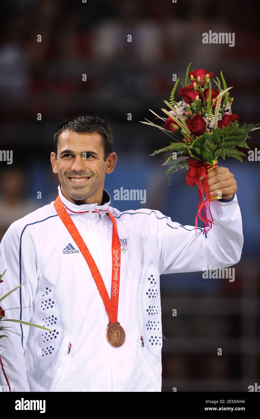 Christophe Guenot of France poses on the ceremony podium with his
