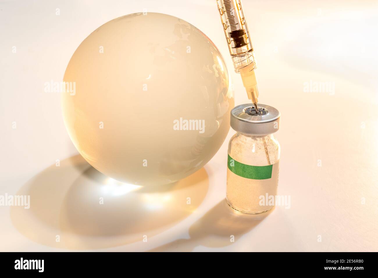 Glass globe and syringe with vaccine and beaker on white background . Global health care concept Stock Photo