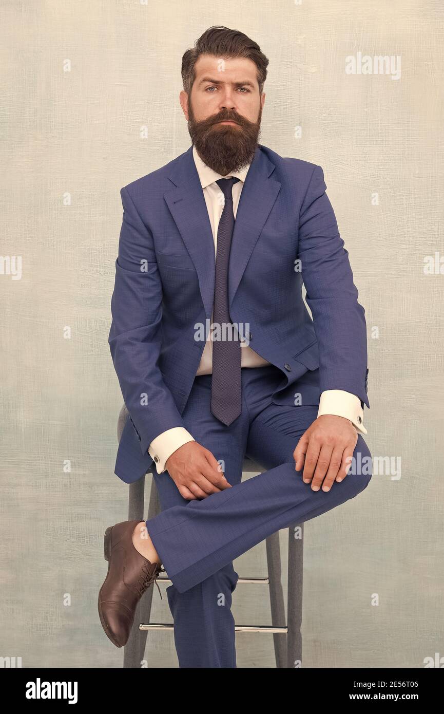 Fairness and justice. Classy and formal. Bearded man wear formal suit.  Elegant lawyer sit on chair. Business meeting. Formal event. Man with beard  and mustache confident lawyer. Your lawyer Stock Photo -