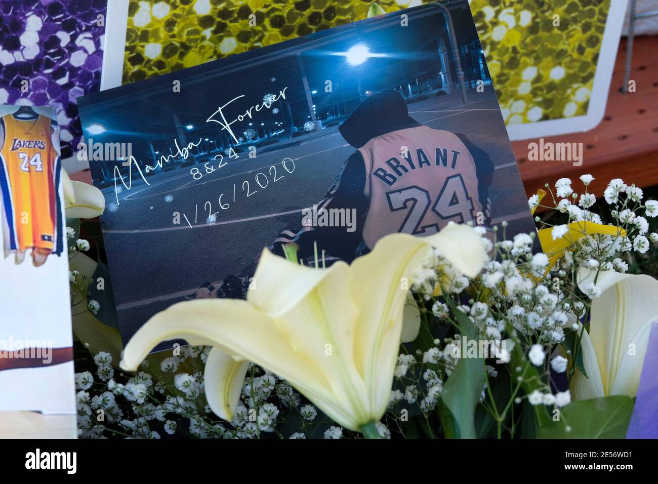 Los Angeles, California, USA. 26th Jan, 2021. Flowers, pictures and messages are placed at a makeshift memorial honoring NBA star Kobe Bryant and his daughter Gigi near Staples Center in downtown Los Angeles, Tuesday, Jan. 26, 2021. Credit: Ringo Chiu/ZUMA Wire/Alamy Live News Stock Photo