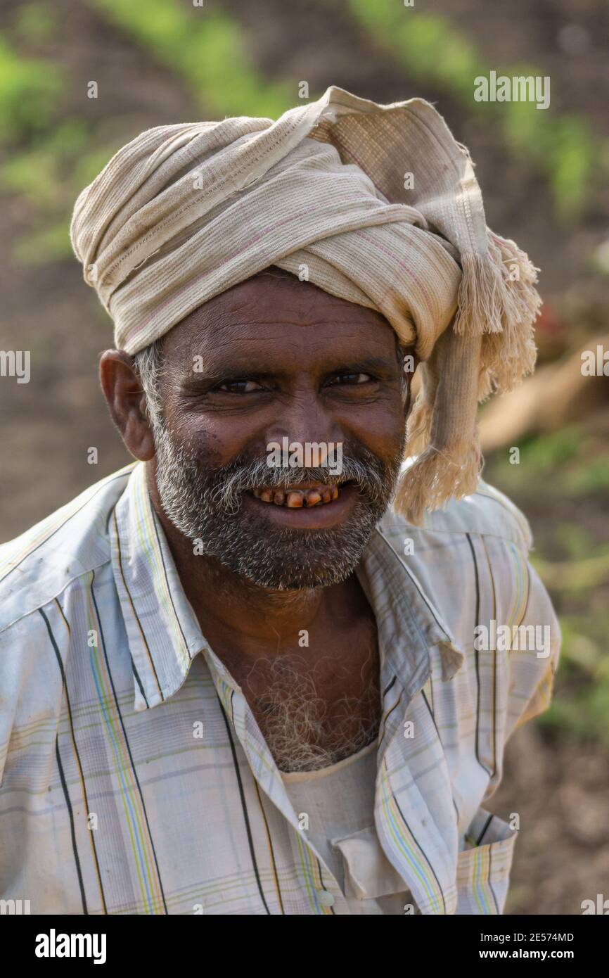 Abbigeri, Karnataka, India - November 6, 2013: Closeup of face of peanut farmer. White turban, graying beard and light shirt. Stock Photo