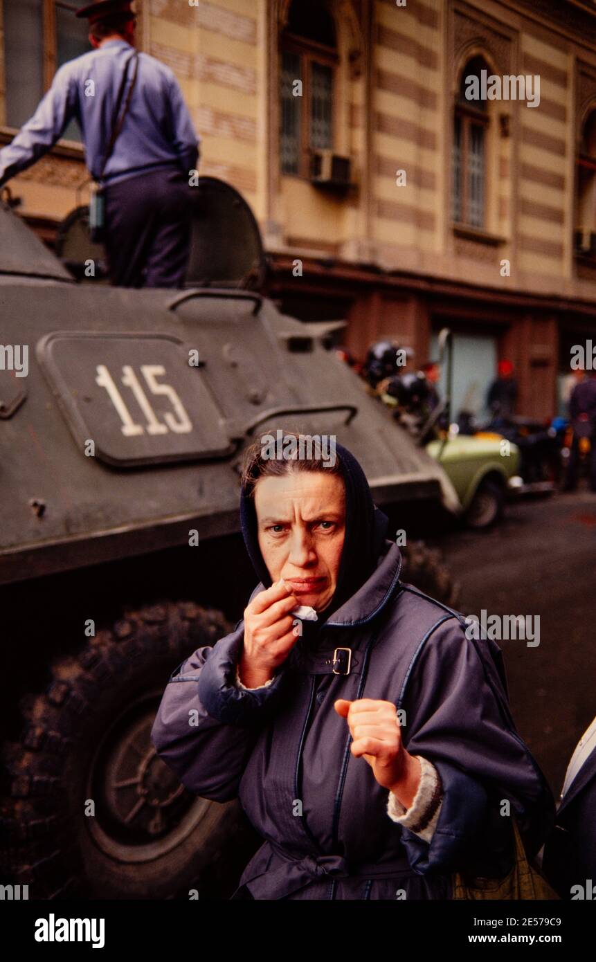 A fearful woman as tanks and armored vehicles roll through Tbilisi, Soviet Georgia. 1990 Stock Photo