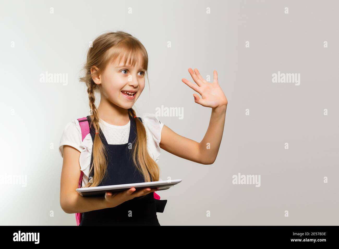 Little Girl Crying Using Tablet The little girl using the tablet on the white wall background Stock ...