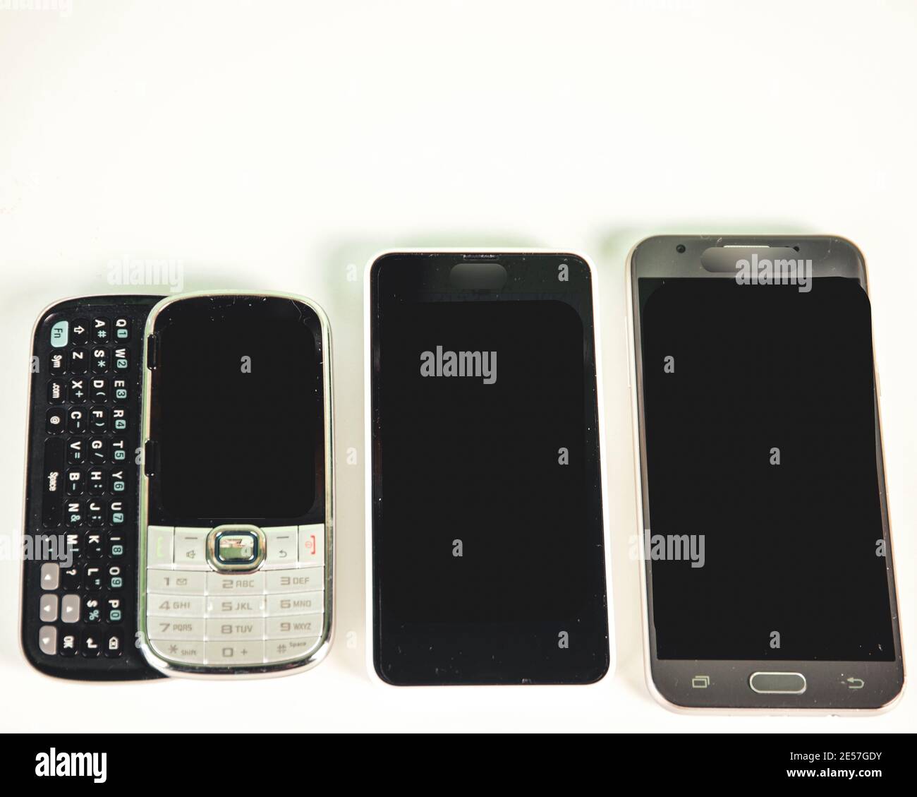 Three different types of phones, slide to a smartphone Stock Photo Alamy