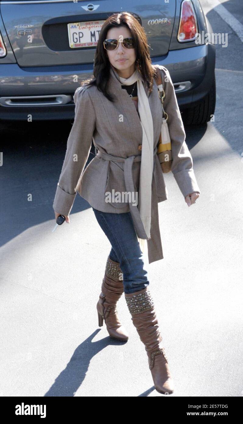Petite actress Eva Longoria sported a scarf and long boots to beat