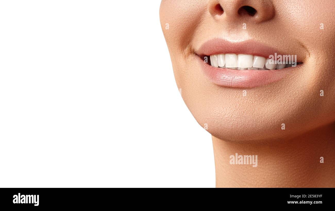 Wide smile of young beautiful woman with perfect healthy white teeth on grey background. Dental whitening, ortodont, care tooth and wellness. Natural Stock Photo