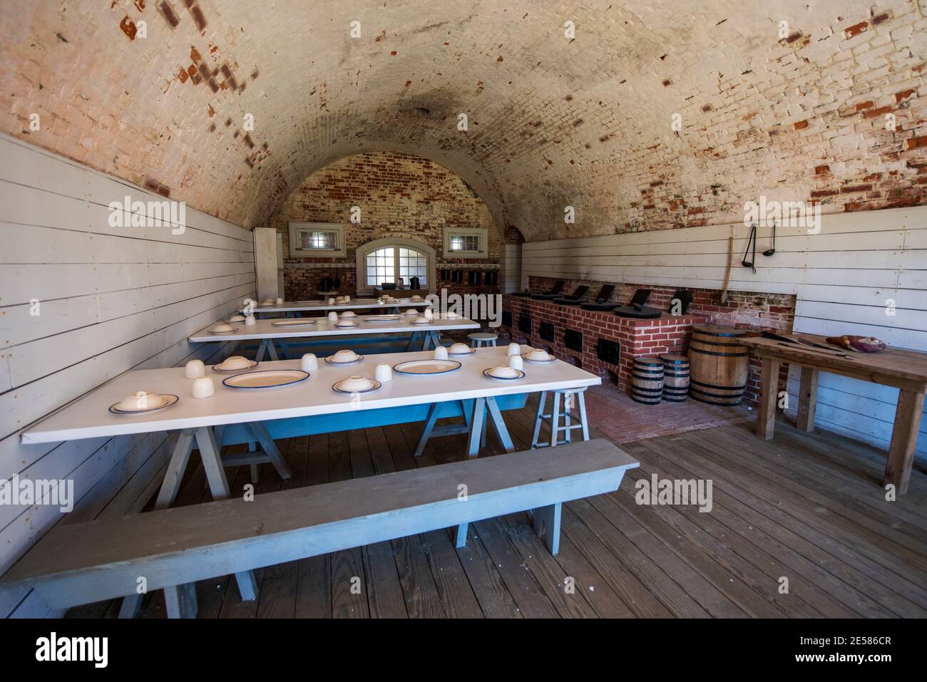 Tables are set in a recreated mess hall at Fort Macon State Park in Atlantic Beach, NC. Fort Macon was constructed after the War of 1812 to defend Bea Stock Photo