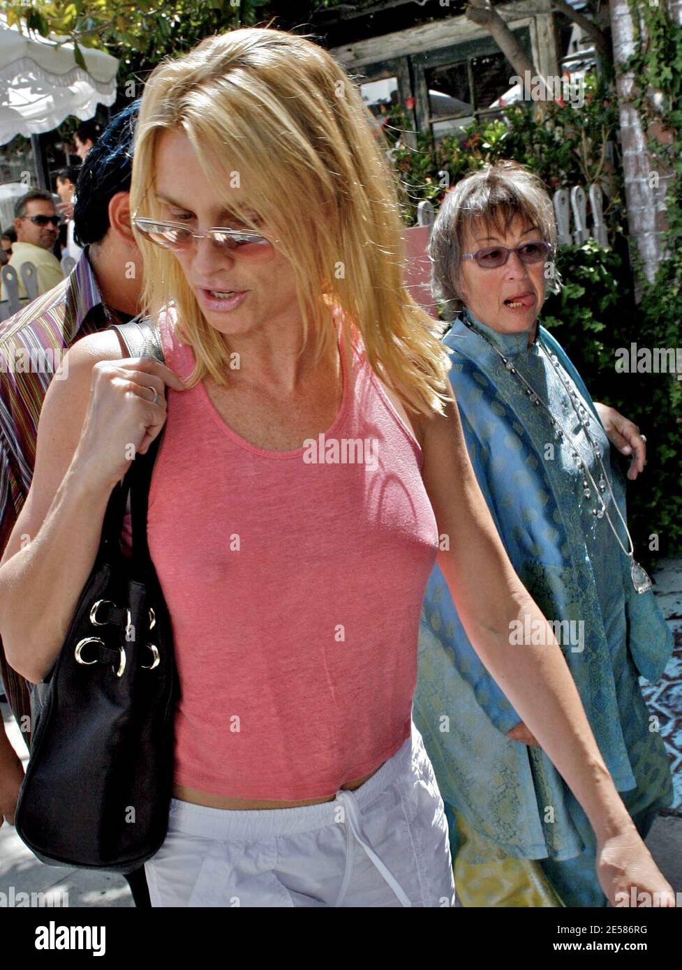 A perky Nicollette Sheridan shops along Robertson Boulevard with friends. The actress bought a new set of clothes but apparently no bra. Sheridan wore the new outfit out of the store and helped her friend to her feet when she fell during the shopping trip. West Hollywood, Calif. 5/24/07.  [[laj]] Stock Photo