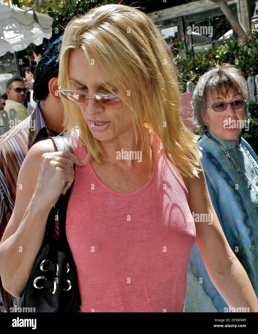 A perky Nicollette Sheridan shops along Robertson Boulevard with friends. The actress bought a new set of clothes but apparently no bra. Sheridan wore the new outfit out of the store and helped her friend to her feet when she fell during the shopping trip. West Hollywood, Calif. 5/24/07.  [[laj]] *** Local Caption *** A braless Nicollette Sheridan shops along Robertson Boulevard in West Hollywood. She even bough a new set of clothes which she wore out of the store. 5/24/2007 Stock Photo