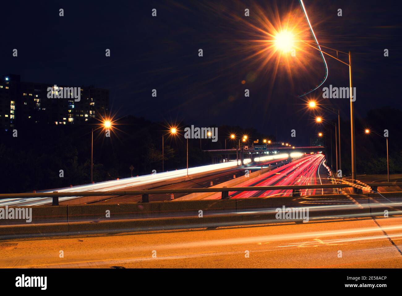 Light trails from vehicles traveling on the interstate 395,  view of the highway from overpass road. Stock Photo
