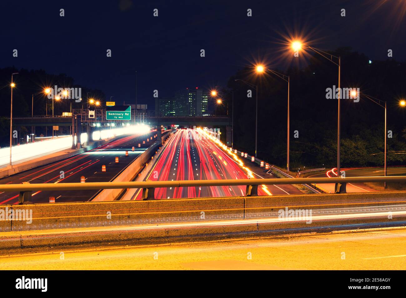 Light trails from vehicles traveling on the interstate 395,  view of the highway from overpass road. Stock Photo