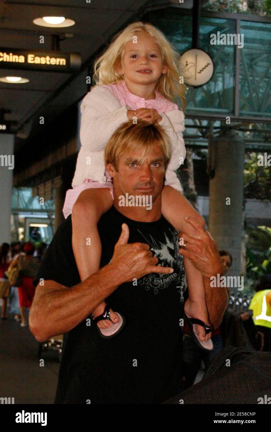 Exclusive!! Laird Hamilton, daughter Reece and wife Gabrielle Reece arrive at LAX airport. Los Angeles, Calif. 7/12/07.   [[wam]] Stock Photo