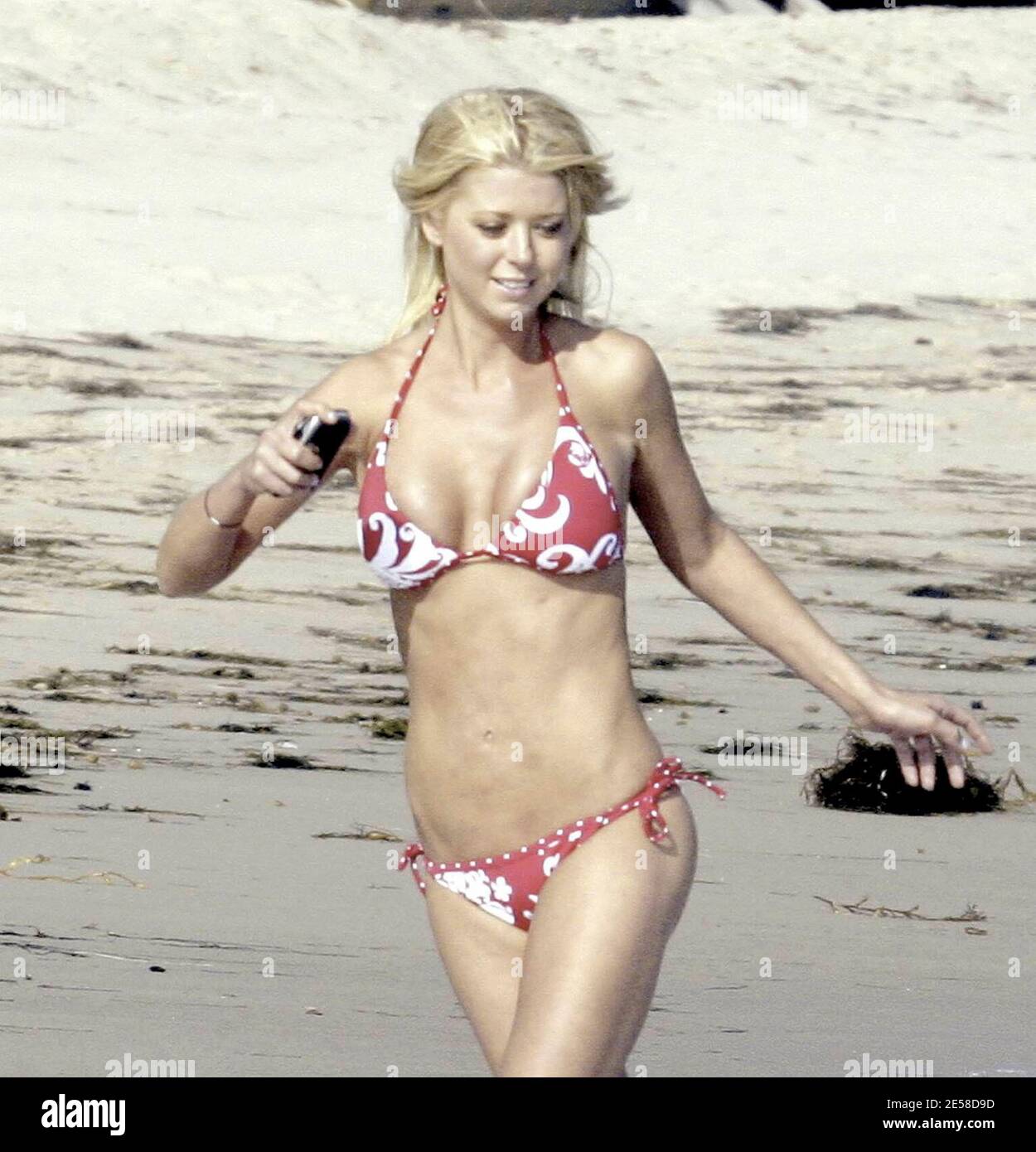 Tara Reid takes to the beach for some fun and games sporting a red and  white bikini. Even though the actress has undergone corrective procedures  for botched plastic surgery, Reid still shows