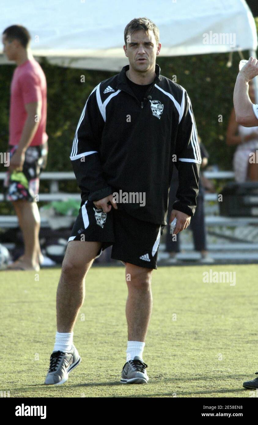 Robbie Williams shows his true colors during an LA Vale soccer match. The  singer sports a salt-and-pepper hairdo while practicing shoeless with a  ball, only wearing a pair of socks. Robbie finally
