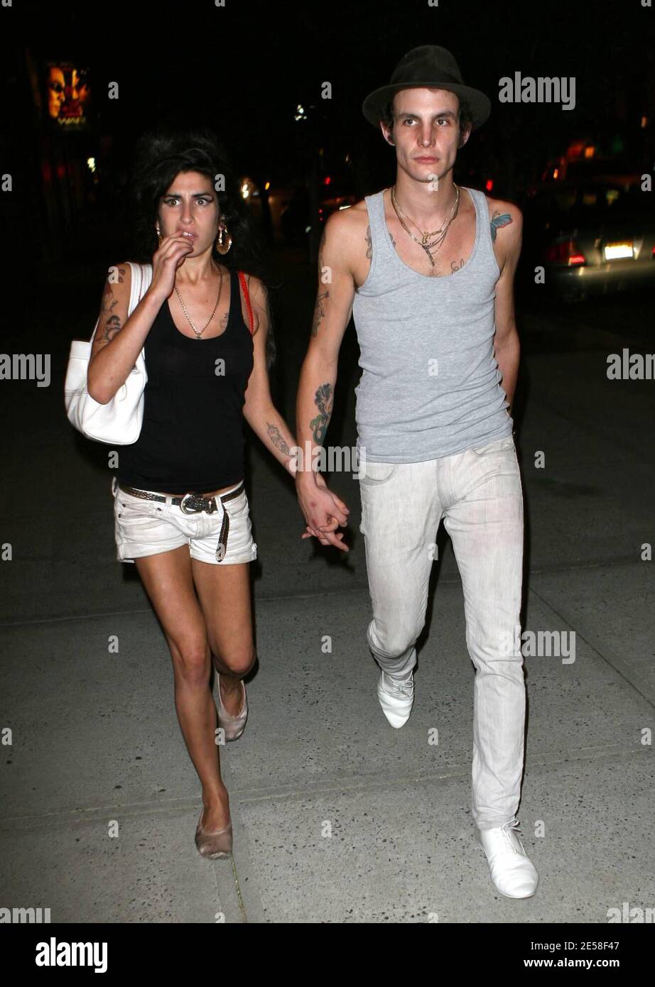 Amy Winehouse and husband Blake Fielder-Civil return from dinner while Amy gets something out of her teeth. The couple signed autographs near their hotel and Amy wore the same grubby white shorts she wore all last week in London. New York, NY. 8/1/07.   [[faa]] Stock Photo