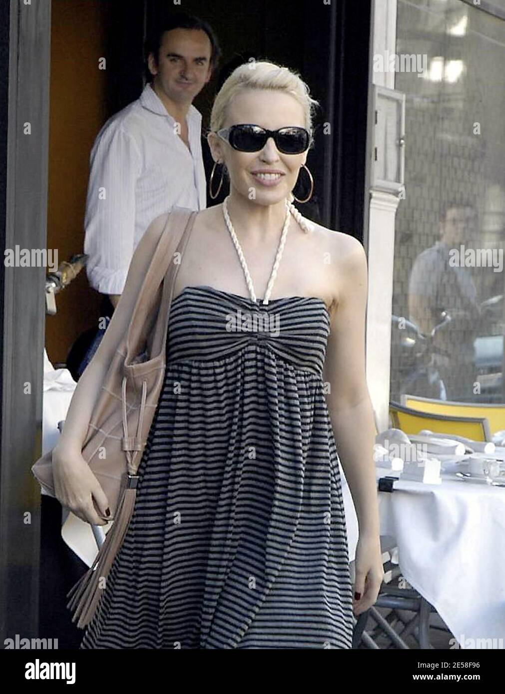 Kylie Minogue leaves her London home and stops into the nearby Cambio De Tercio cafe with a friend for lunch. Kylie threw a party to celebrate 20 years of success following her first hit single 'Locomotion.' London, UK. 8/4/07.   [[map]] Stock Photo