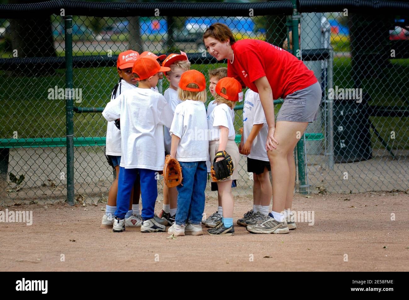 5 to 7 year old boys and girls taking baseball lessons by being ...
