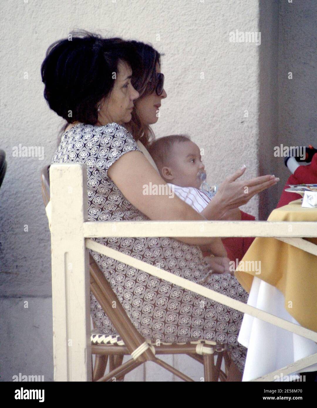 Exclusive!! Actress Paz Vega, husband Orson Salazar and four month old son Orson share a family day out. The proud new parents played with their son over lunch and took lots of photos to capture the moment. Little Orson was full of smiles and giggles. They were joined by an older woman who appeared to be Paz's mother (check). Beverly Hills, Calif. 9/16/07.    [[rac ral]] Stock Photo