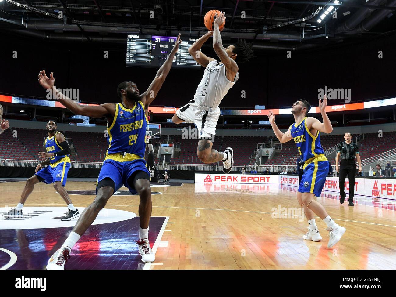 Riga, Latvia. 26th Jan, 2021. Kyle Allman (C) of VEF Riga shoots during the group E match at Europe Basketball Champions League between VEF Riga and Peristeri in Riga, Latvia, on Jan. 26, 2021. Credit: Edijs Palens/Xinhua/Alamy Live News Stock Photo