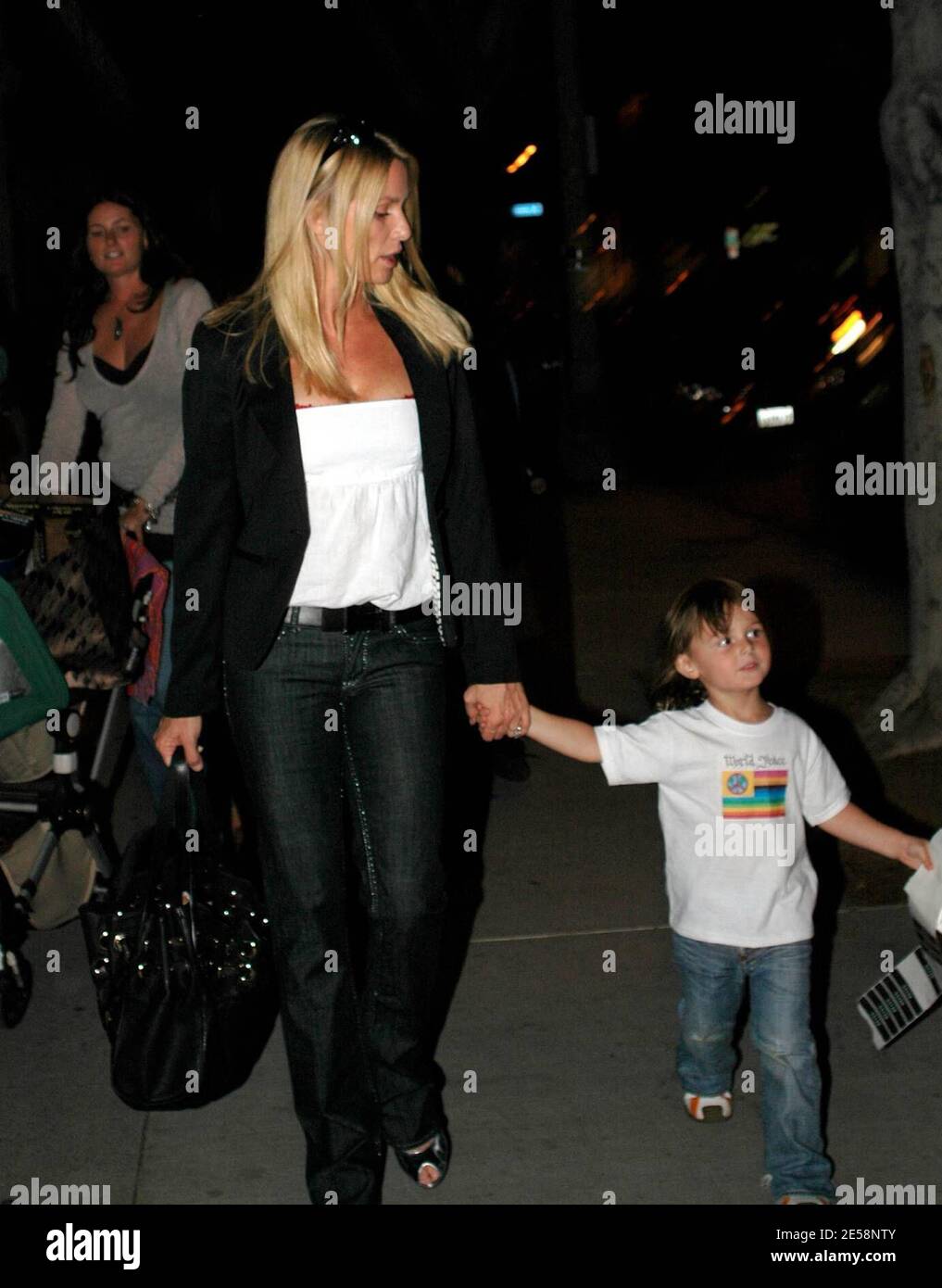 Nicollette Sheridan and a young friend fool around with photographers on Robertson Blvd. Los
