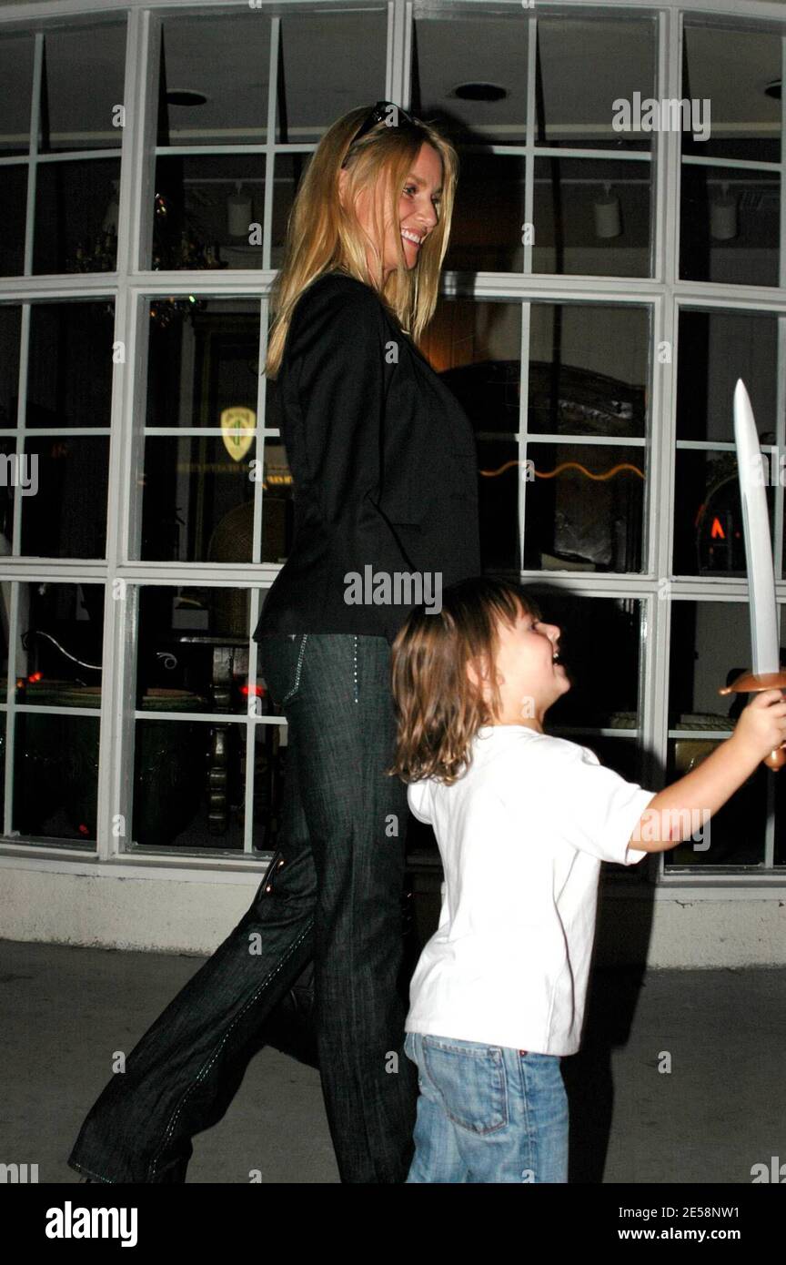 Nicollette Sheridan and a young friend fool around with photographers on Robertson Blvd. Los
