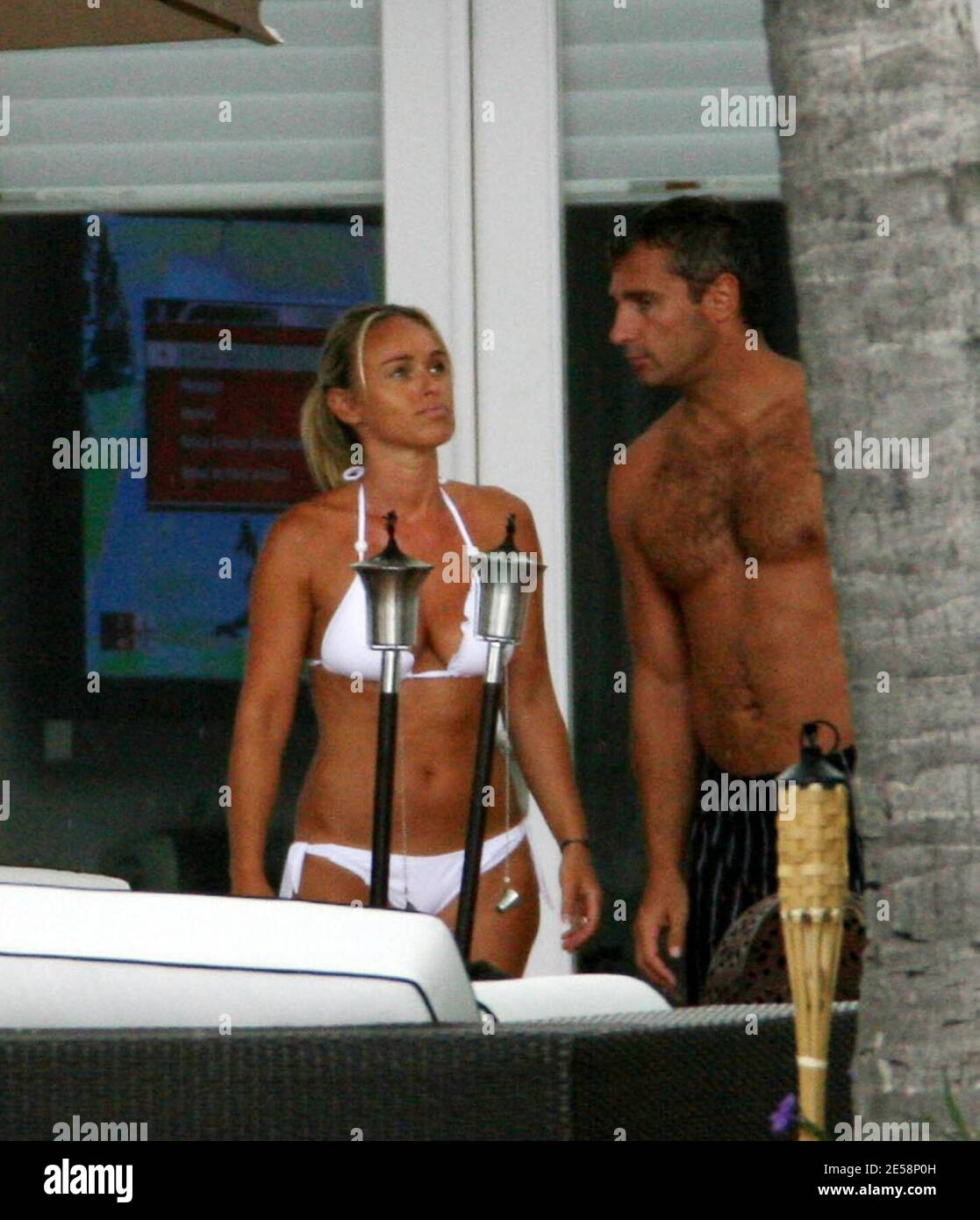 Exclusive!! Cecile de Menibus and Yann Delaigue spend time poolside with  friends at a luxury mansion in Miami Beach, FL. Cecile looked great in a  white bikini and Yan practised his rugby