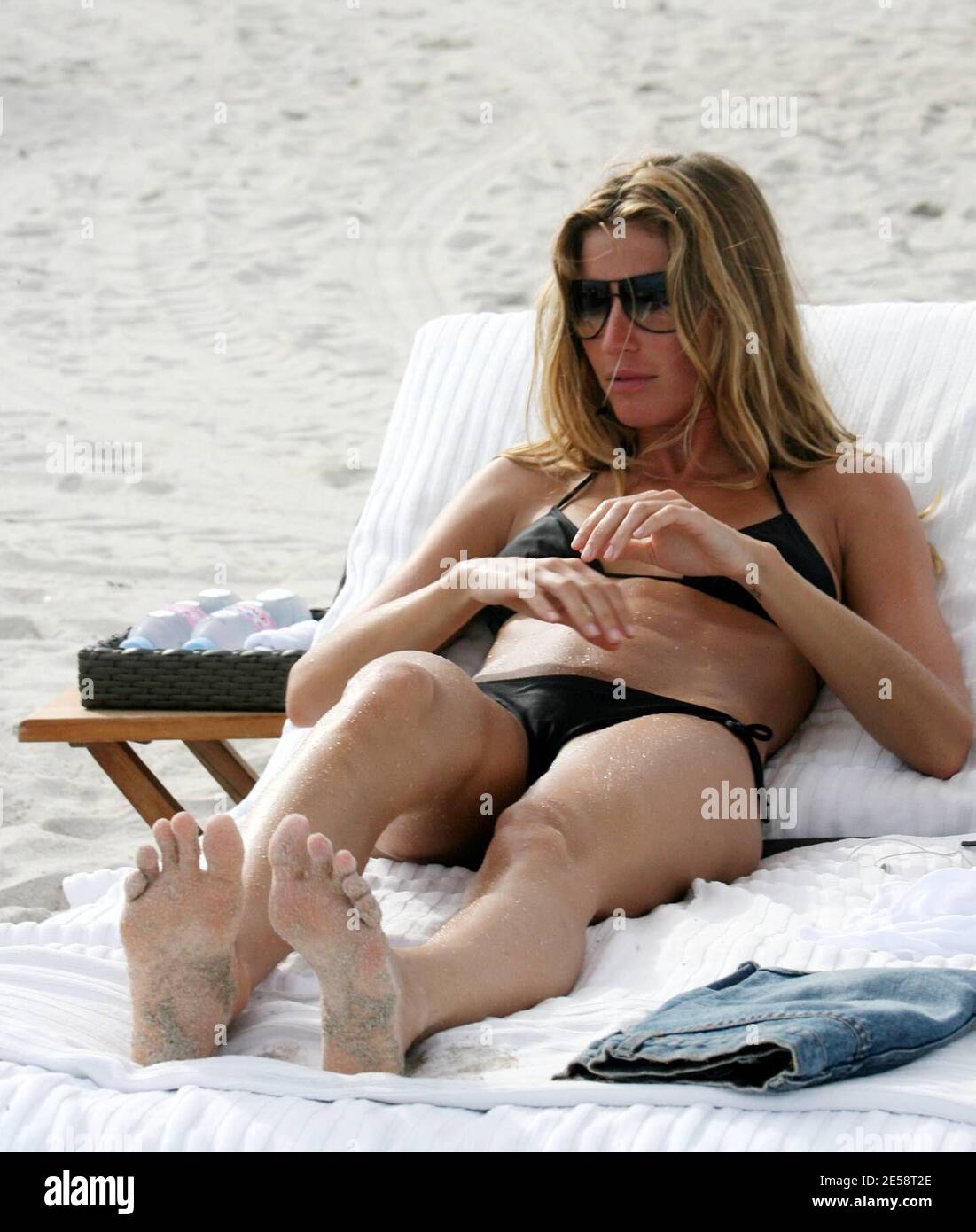 Supermodel Gisele BŸndchen chills out with a friend on Miami Beach. She is  in town to support boyfriend, New England Patriot football star Tom Brady  whoÕs team is playing a game against