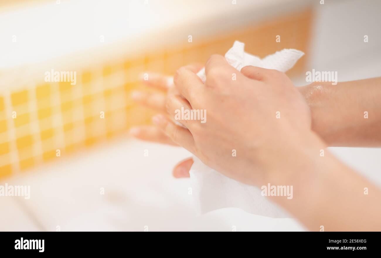 Female hand use antibacterial wet wipes or tissue after washing hand