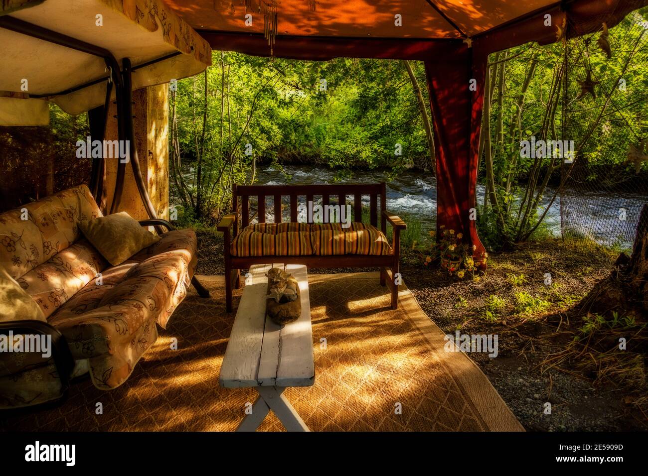 An inviting streamside cabana along the John Day River near Prairie City, Oregon Stock Photo