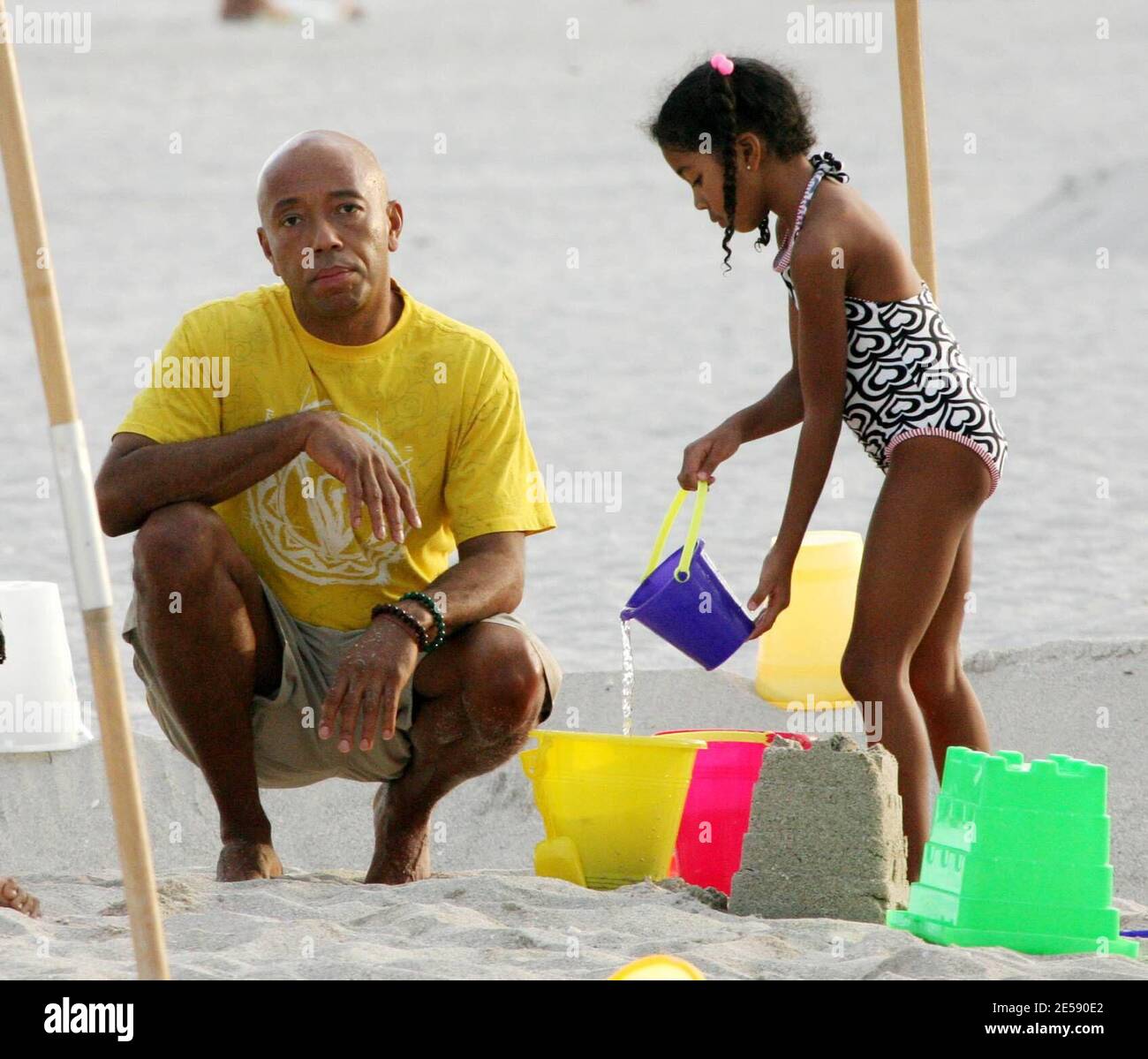 Hip Hop Mogul Russell Simmons takes daughters Ming Lee and Aoki Lee Kyoko to play sandcastles with his new girlfriend, model Porschla Coleman. Ex wife Kimora is also in town doing a personal appearance. Miami Beach, FL. 12/5/07.   [[tag mab]] Stock Photo