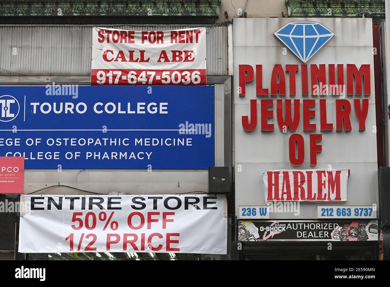 Retail stores advertising discounts along 125th Street in the Harlem