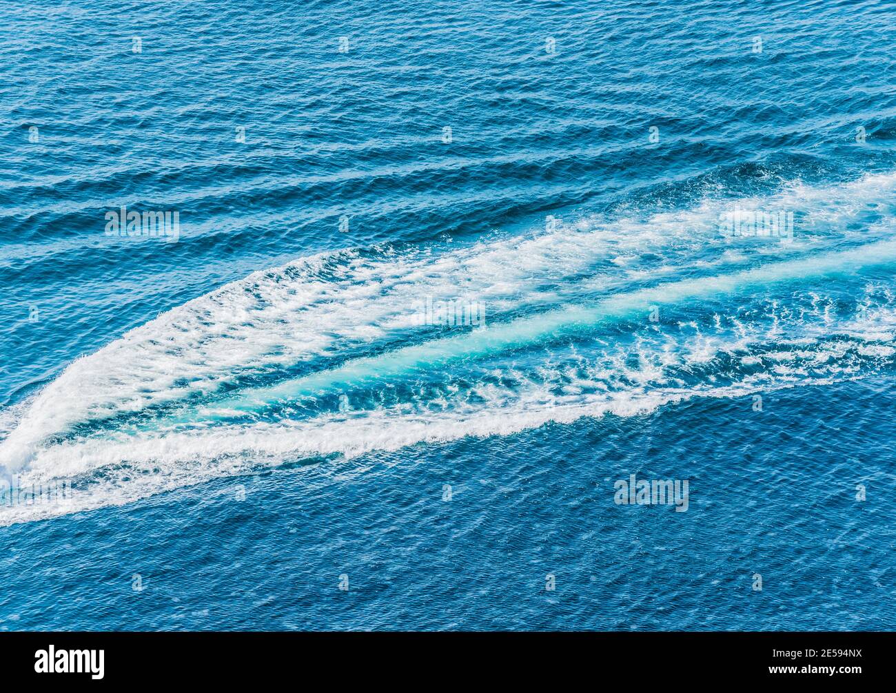 Trail on water surface behind of fast moving motor boat Stock Photo - Alamy