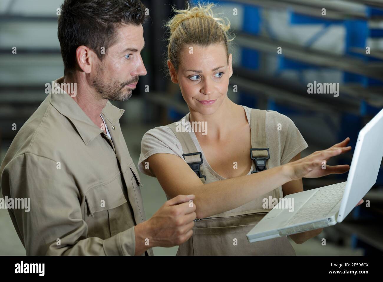 technicians using computers overlooking vats Stock Photo