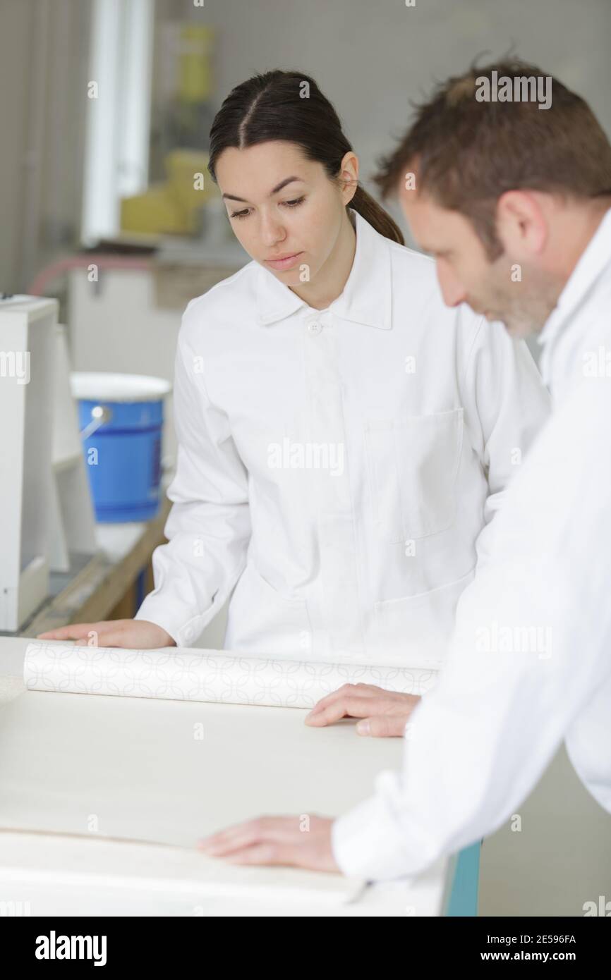 the painter is working with an apprentice Stock Photo