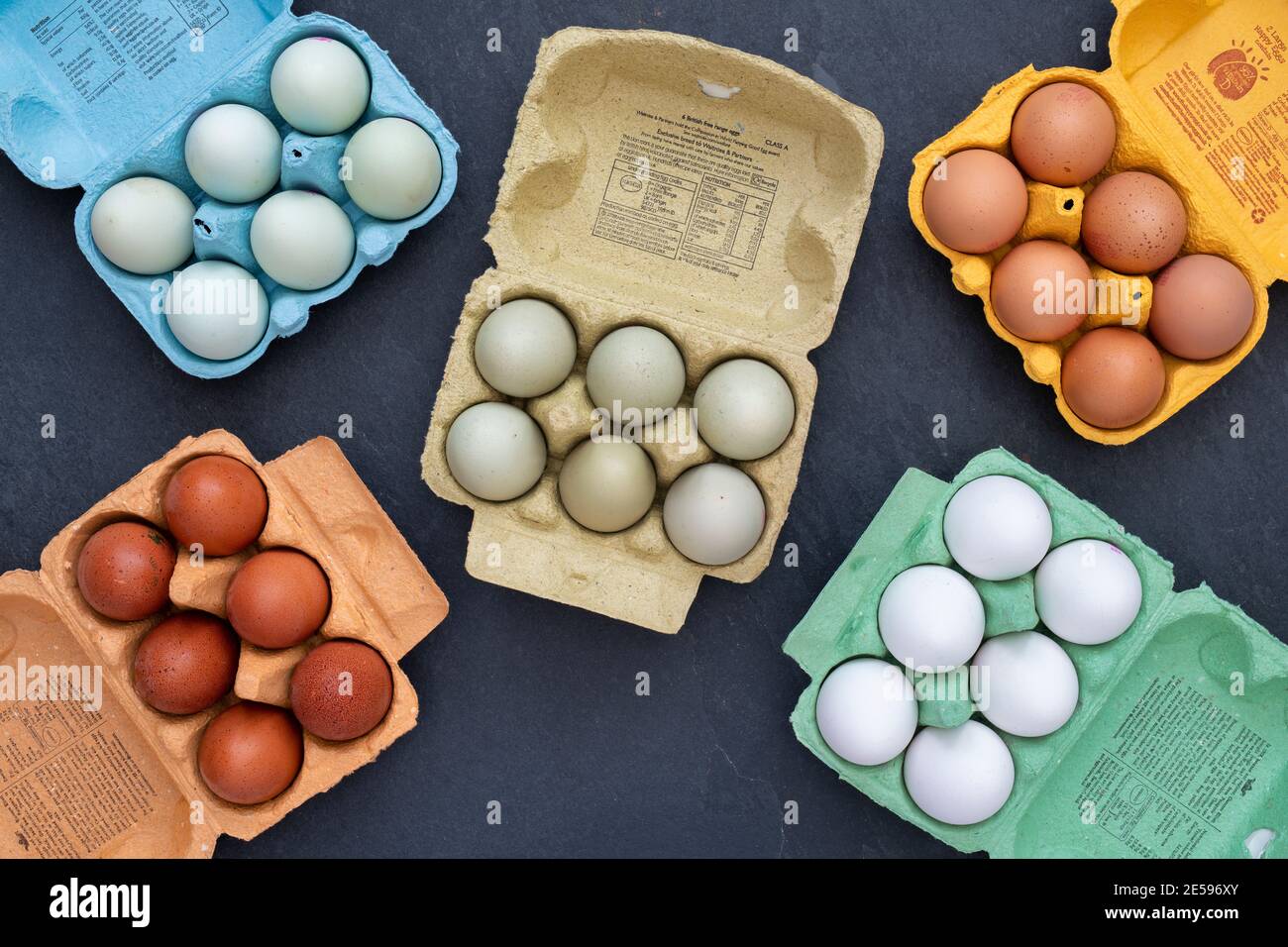Different types of free range eggs in boxes on a slate background Stock Photo