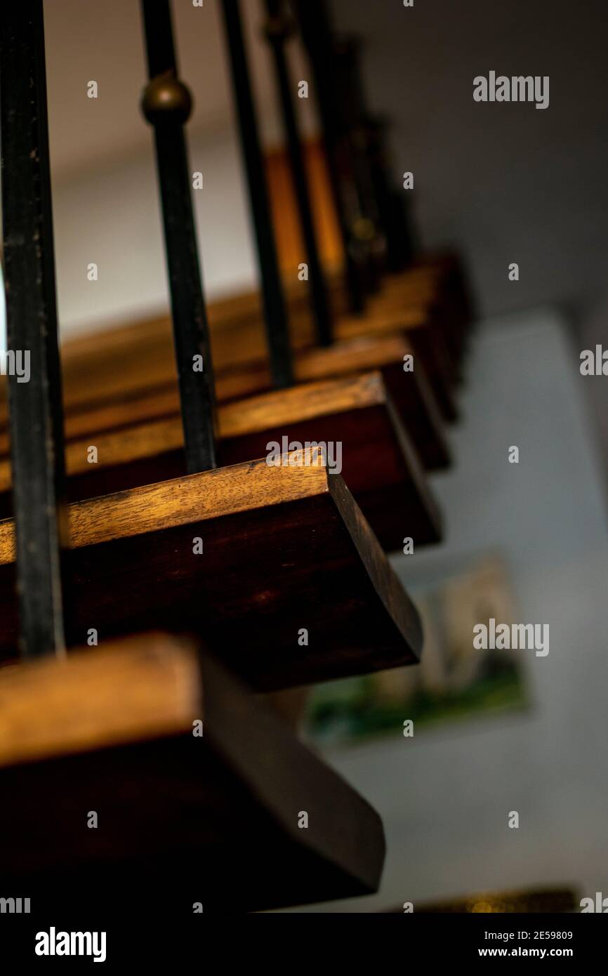 Close up shot of an old wooden indoor house stair with shallow depth of field. Stock Photo