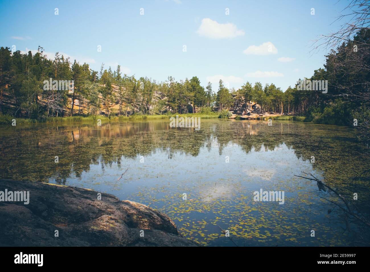 Mountain lake in the background of mountains and blye sky Stock Photo