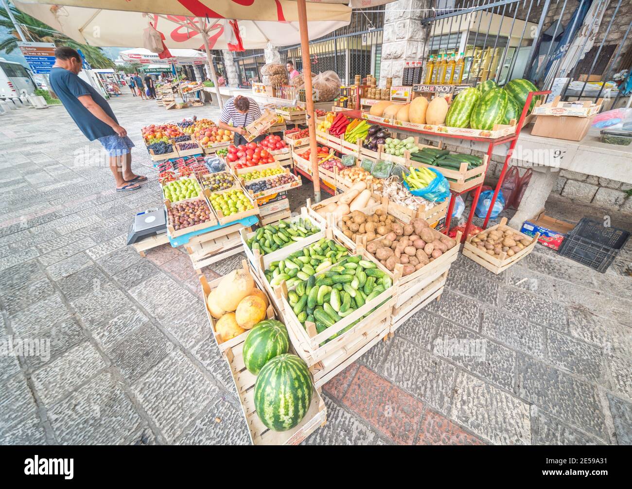 Fruit and vegetables on sale in wooden crates at an outside market next ...