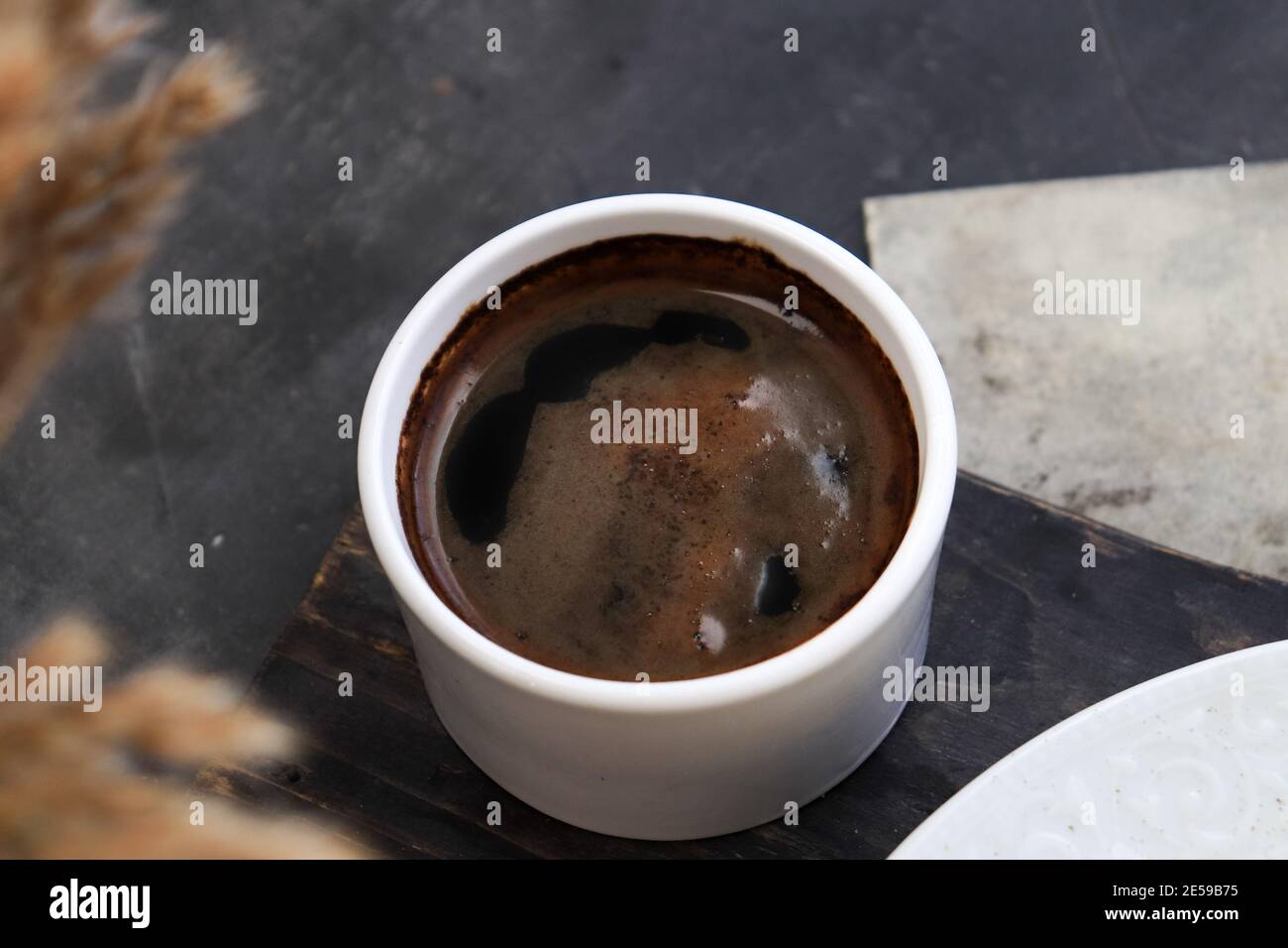 greek coffee served in a white cup. Turkish coffee in a cup Stock Photo