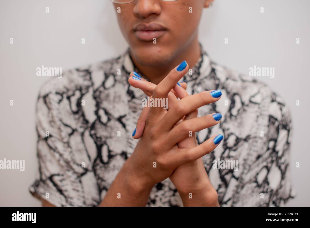 Portrait of young man with blue nail polish Stock Photo