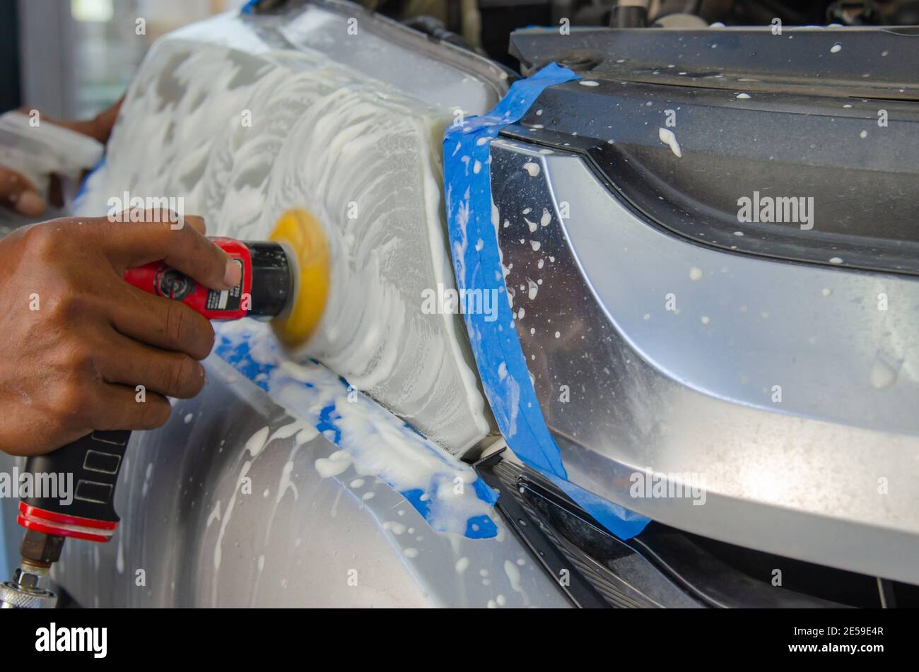 Car headlight cleaning service with a headlight polishing machine Stock