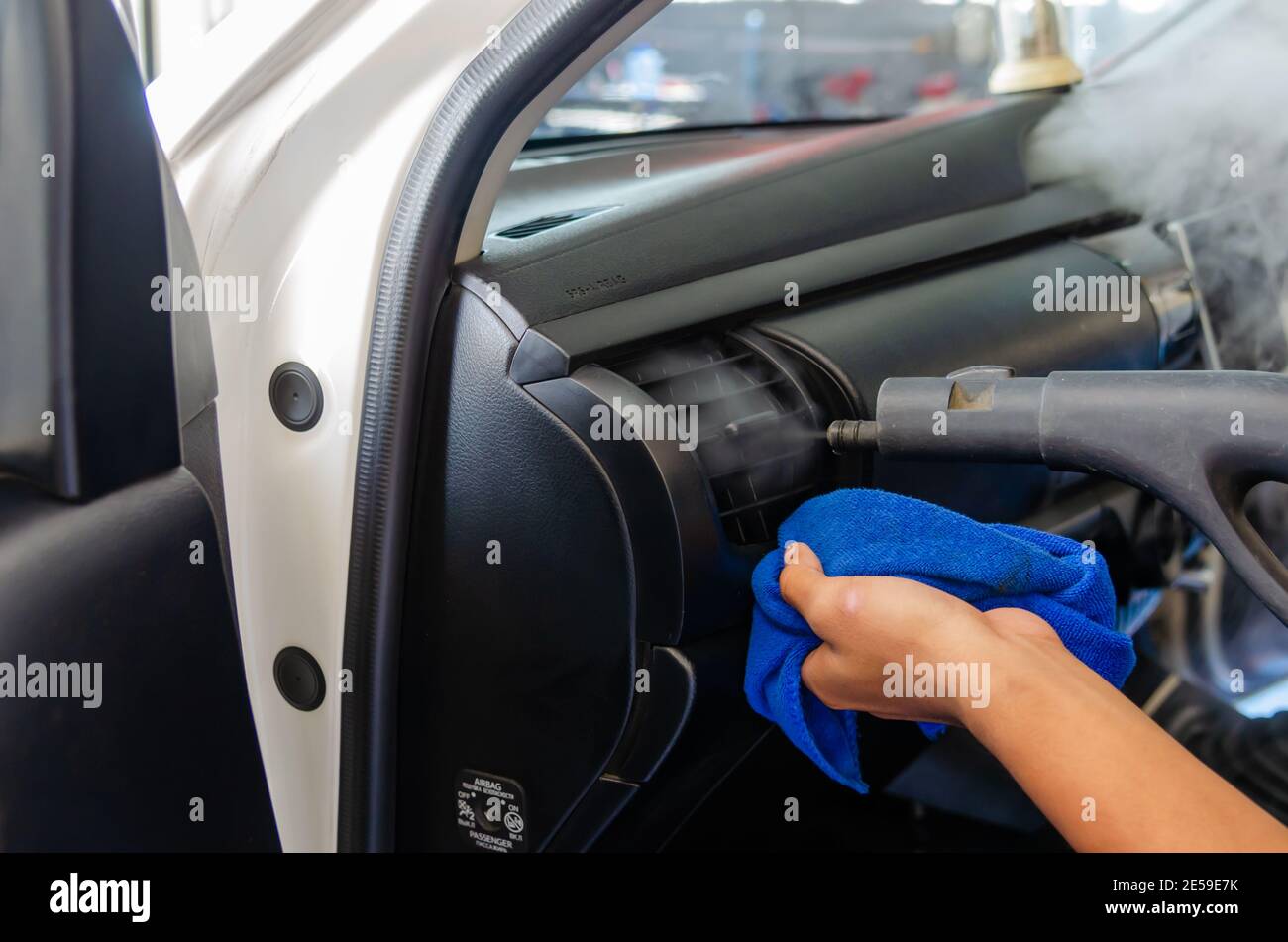 Steam cleaning in the car's air vents. Use high heat steam to kill germs to clean at the car service. Stock Photo