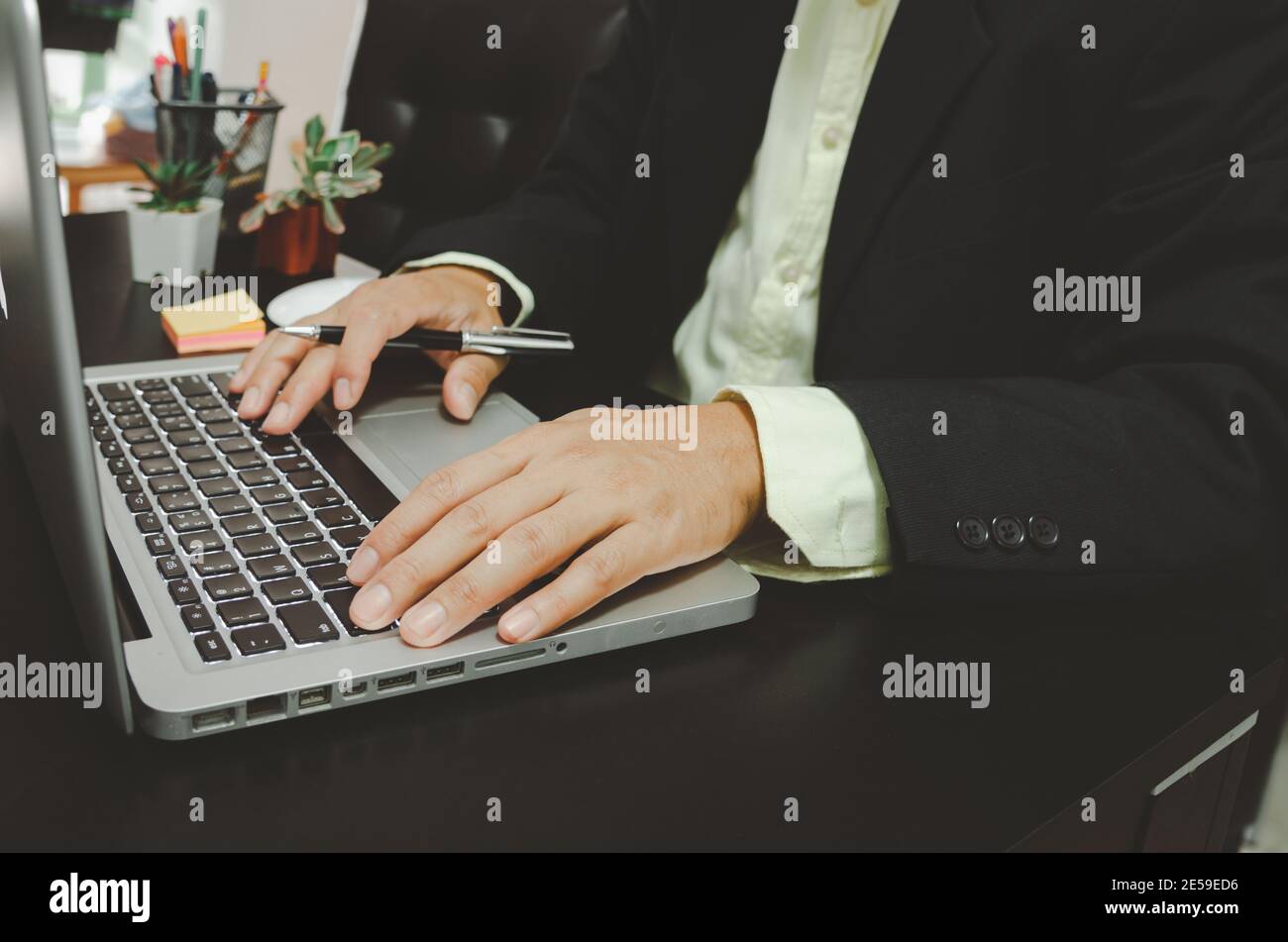 Businessman seacrh find information on Internet social media with computer laptop on desk. work for home. Stock Photo