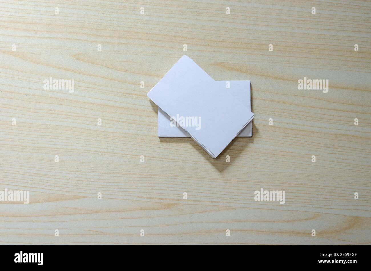 Blank Paper Mockup for Business Cards on wood. Stock Photo