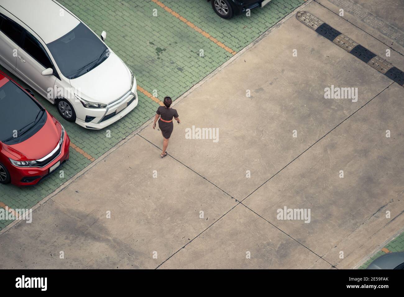 High angle view woman walking in parking lot Stock Photo