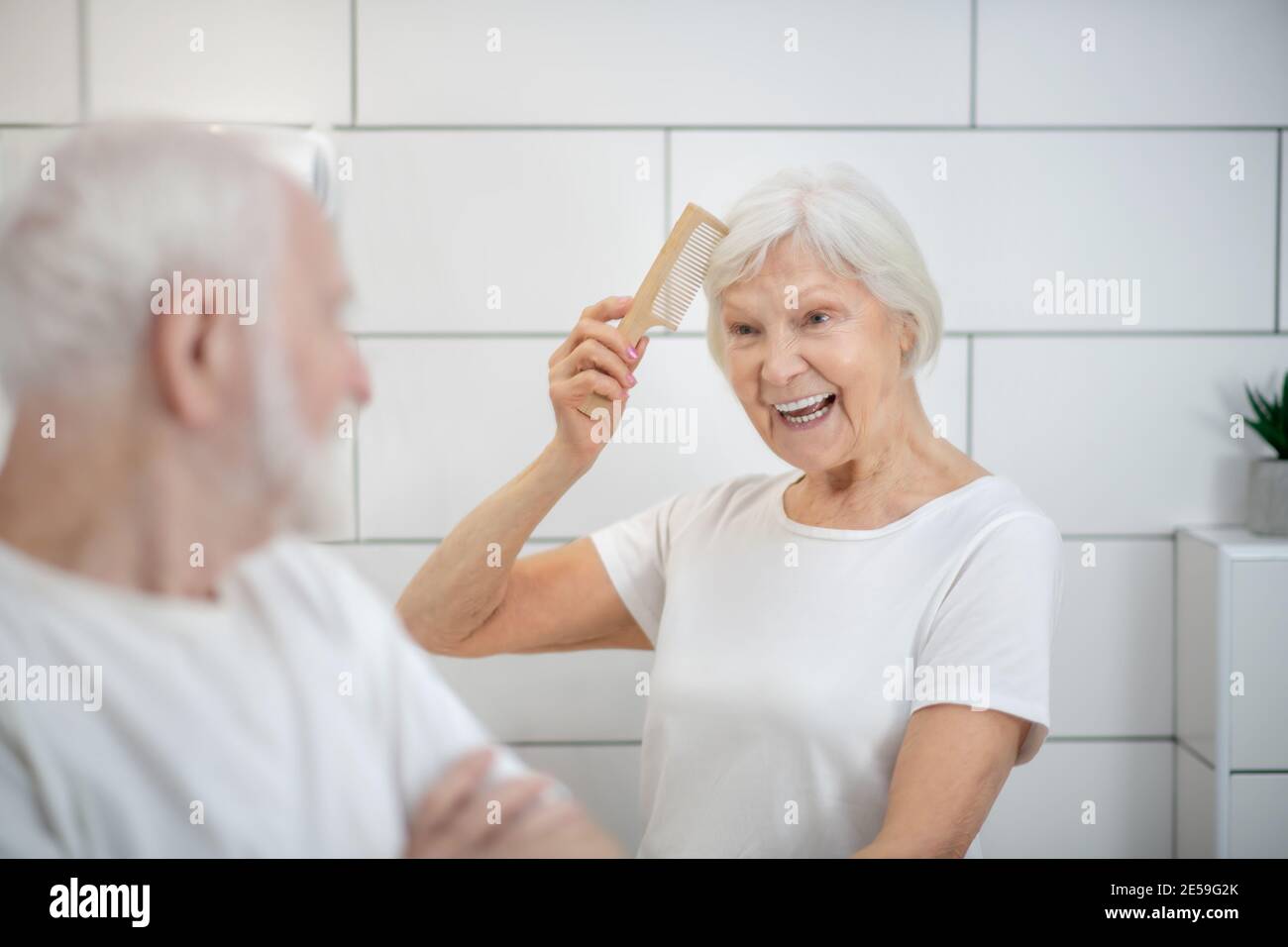 Elderly couple having their morning procedures together and looking happy Stock Photo
